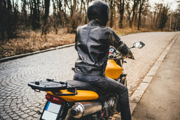 istock Man with helmet on motorcycle 1364257779