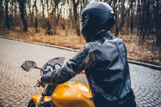 istock Man with helmet on motorcycle 1364258116