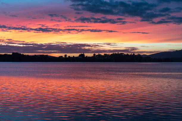 istock Intense sunrise reflects red on water 1364259814