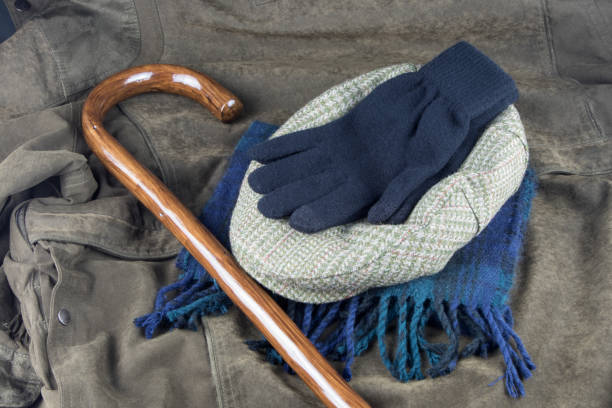walking stick with scarf gloves and cap on an outdoor coat - scarf hat green glove imagens e fotografias de stock