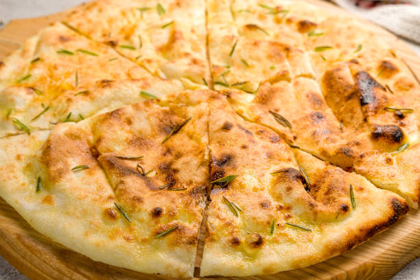 istock Focaccia with rosemary on the board on grey concrete table macro close up 1364261066