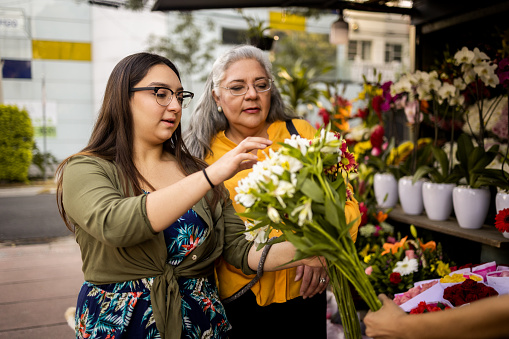 Mother and daughter choose the bouquet at the local flower shop