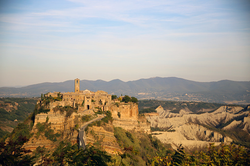 Panorama of the cliff below Civita di Bagnoregio and the Calanchi valley, in the golden light of sunset, Civita di Bagnoregio, Tuscia, Lazio, Italy