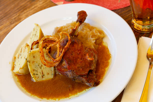istock Confit duck leg with sauerkraut and dumplings 1364263361