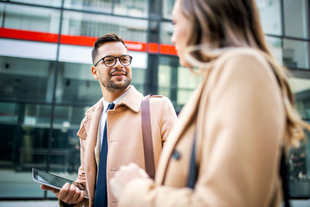 istock Smiling Business people going to work in morning talking and walking 1364264869