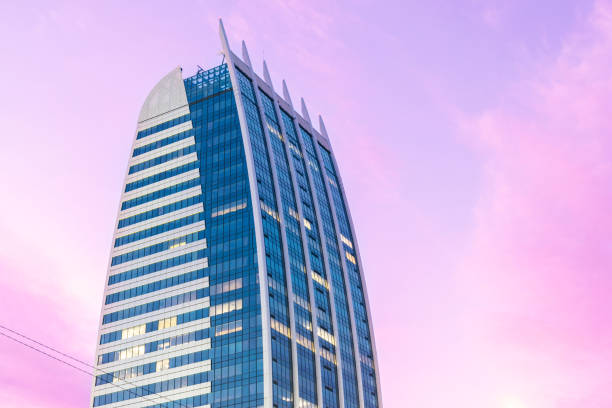 Highly detailed abstract modern architecture futuristic building on dramatic sunset sky. Minimalistic style. Beautiful sunset sky in purple. Perfect for background, copy space and more. Shot in Sofia, Bulgaria.
