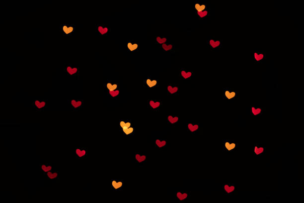 istock Heart-shaped bokeh lights on a black background 1364265290