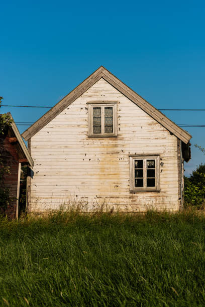 istock Old abandoned white wooden house. 1364266395