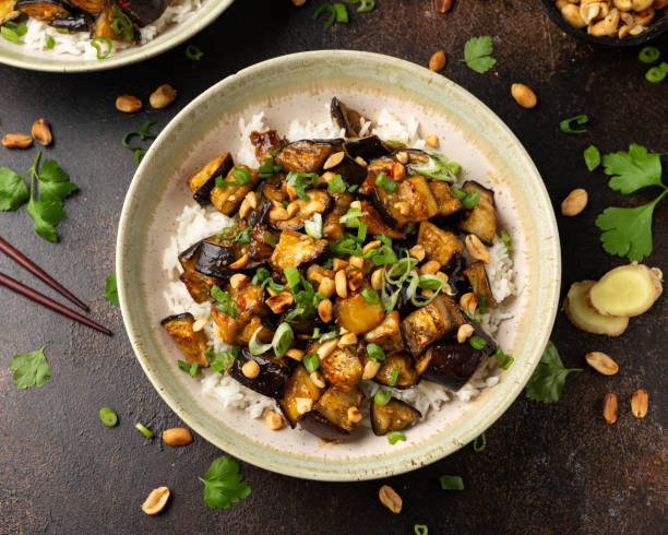 istock Asian Eggplant with rice, peanuts and spring onion. Healthy food. 1364268741