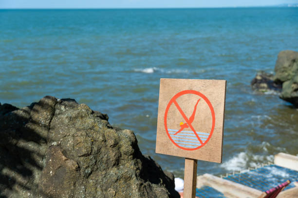 Photo of Close-up of a forbidding sign to dive from a cliff, cliff into the sea on a sunny summer day, copy space