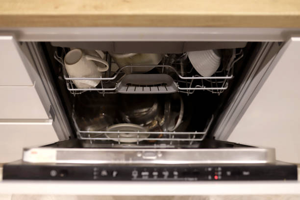 istock Open dishwasher with clean dishes in white kitchen 1364270925