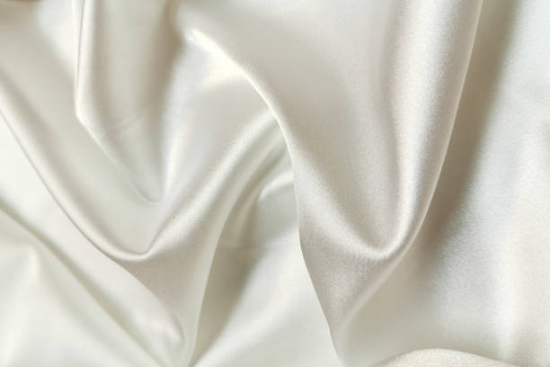 istock White crumpled or wavy fabric texture background. Abstract linen cloth soft waves. Creases of satin, silk, and cotton. Smooth elegant silk or atlas luxury cloth texture. Bedding Sheets or blanket 1364272270