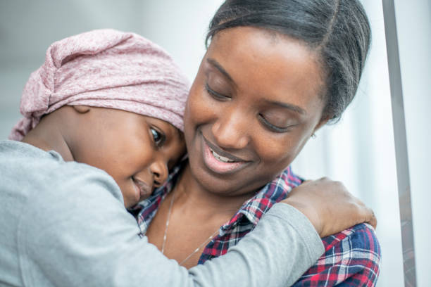 istock Boy with Cancer Hugging His Mom 1364273320