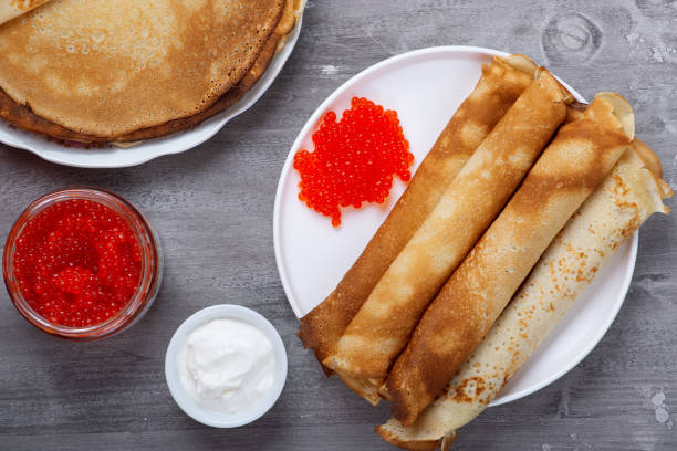 istock Stack of russian thin pancakes blini with red caviar and fresh sour cream 1364276180