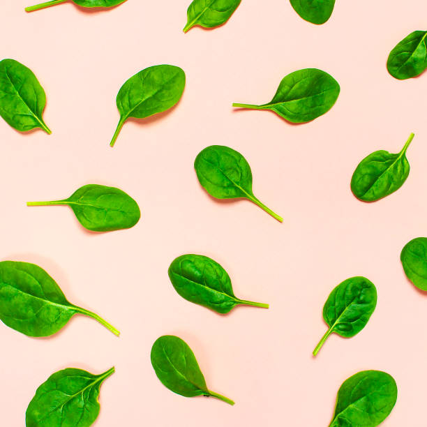istock Fresh green spinach leaves pattern on pink background Flat lay top view. Creative food concept. Ingredient for salad. Vegetable pattern design. Healthy lifestyle. 1364279554
