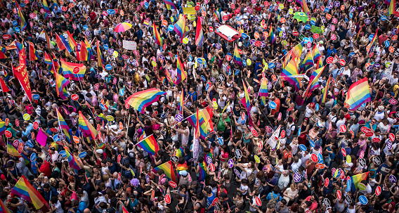 Istanbul, Turkey - June 2013: People in Taksim Square for Istanbul LGBT pride parade. Almost 100.000 people attracted to pride parade and was the biggest gay pride ever held in Turkey.