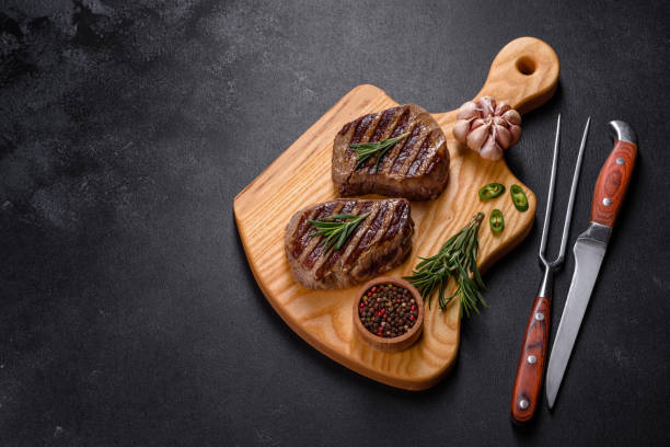 istock Fresh juicy delicious beef steak on a dark background 1364280731