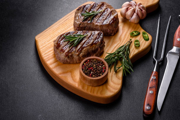 istock Fresh juicy delicious beef steak on a dark background 1364280732