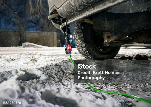 istock Extension cord plugged into vehicle in winter 1364280770