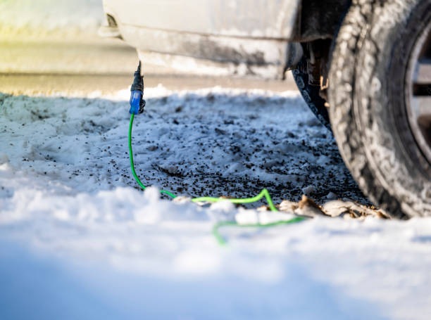 istock Extension cord plugged into vehicle on cold day with copy space 1364280771