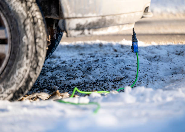 istock Side view of extension cord plugged into vehicle on cold day 1364280777