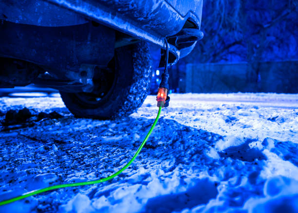 istock Extension cord plugged into vehicle on freezing cold night 1364280788