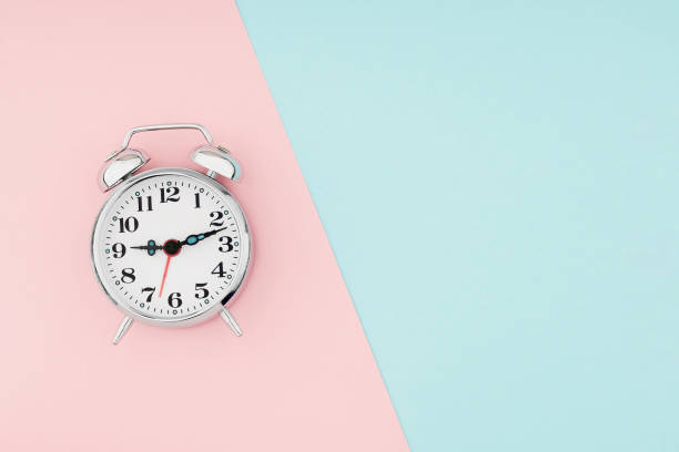 istock Alarm clock on colorful paper background 1364281463