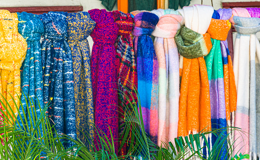 A row of colorful woolen scarves are displayed outside a shop in St. Augustine, Florida on an early January morning.