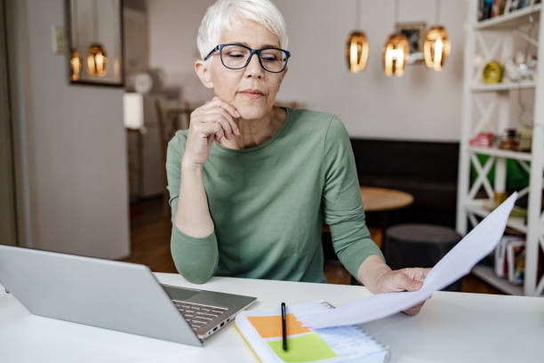 istock Handsome Caucasian senior woman working from home 1364285235