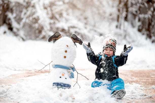 istock Little boy having fun on snow 1364285504