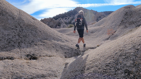 Hiker explores desert landforms