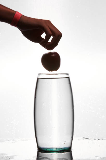 A drop of cosmetic preparation falls from a pipette filled with bubbles. Perfect for showcasing your product.