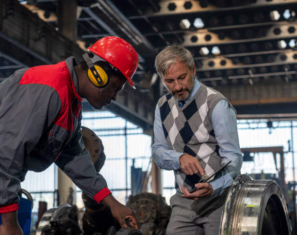 istock Quality Control Inspector Using Digital Tablet And Talking To African American Worker At Train Factory 1364290475