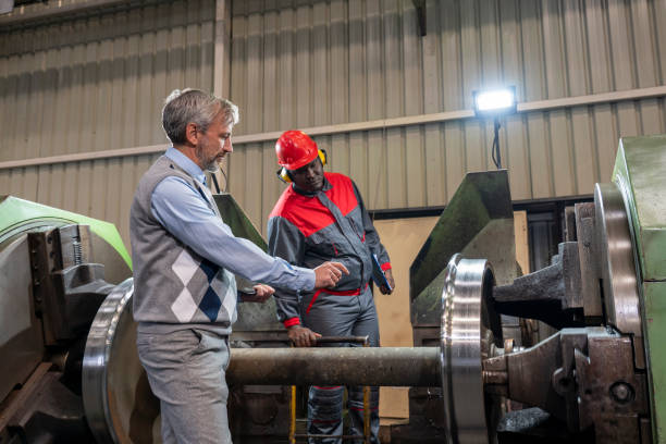 istock Production Supervisor Talking To African American CNC Machine Operator In A Train Factory 1364290481