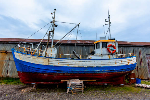 wooden fishing boat in storage in the plains at the end of the fjord at Borgarfiordur Eystri in Iceland