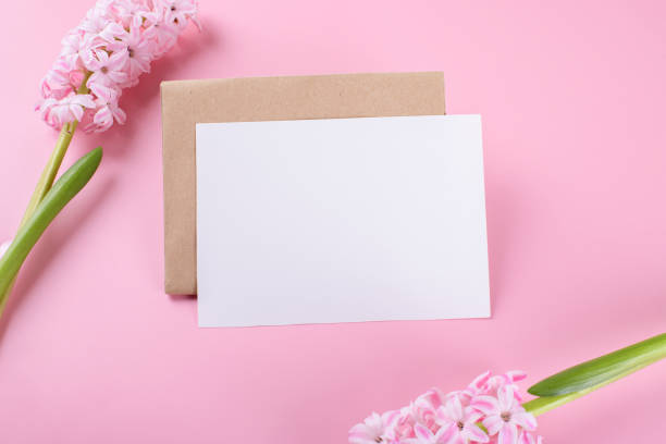 istock Blank wedding invitation stationery card mockup with envelope on pink background with hyacinth flowers 1364291249