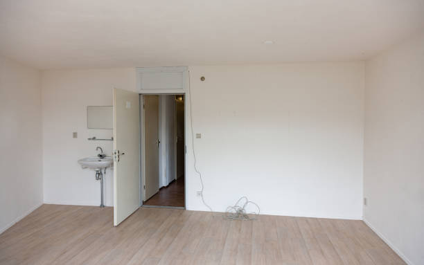 Empty student room with white walls and parquet floor stock photo