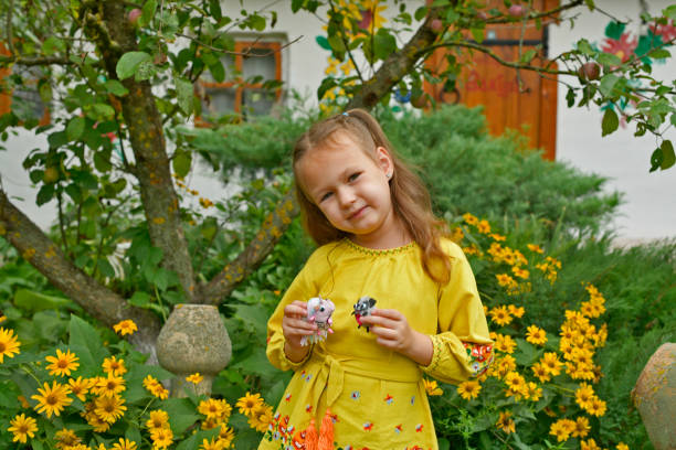 Cheerful portrait of a smiling happy blond boy with a sunflower