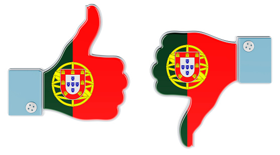 Portuguese flag painted on the hand with thumb up and thumb down. Like and dislike in Portugal, concept. 3D rendering isolated on white background