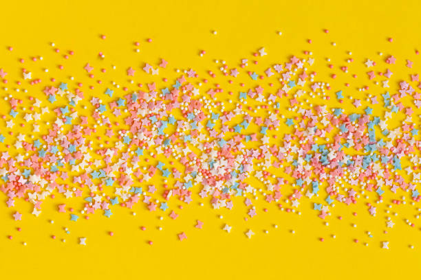 istock Colorful sprinkles on a yellow background 1364297918