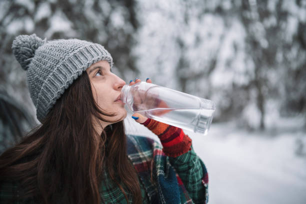 istock Young Woman Drinking Water In Winter 1364299660