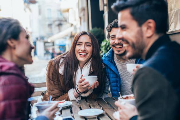 istock Friends talking and laughing in a cafe 1364300532