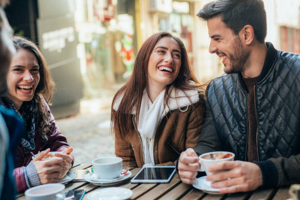 istock Friends talking and laughing in a cafe 1364300697