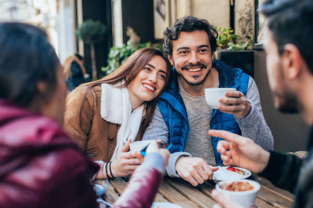 istock Friends talking and laughing in a cafe 1364300735
