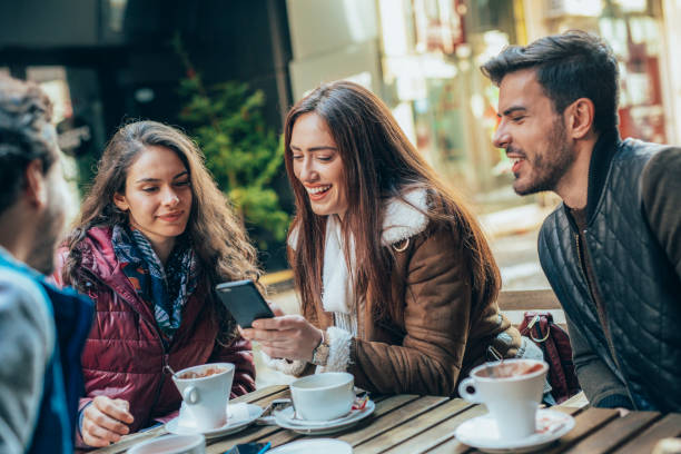istock Friends talking and laughing in a cafe 1364300736