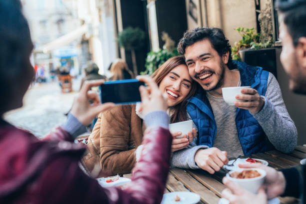 istock Friends talking and laughing in a cafe 1364300740