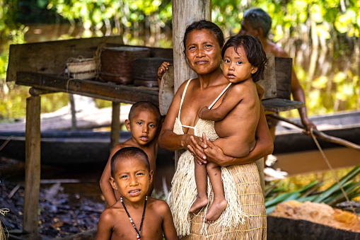 Orinoco, Venezuela - 11-23-2021: Native tribal Orinoco river family portrait wearing traditional clothes close up