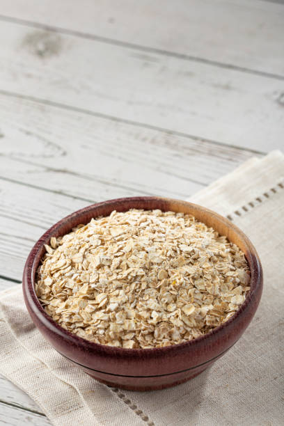 istock Oat flakes in wooden bowl. 1364302852