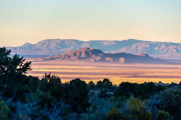 A train rolls through desert farmland near Kingman, Arizona. Viewed from atop Hualapai Mountain.