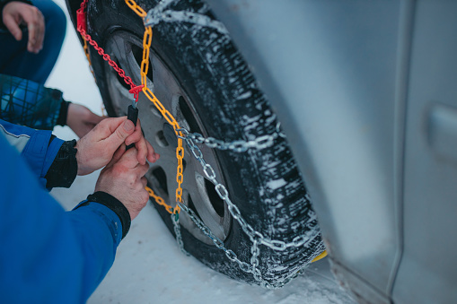 Colorful snow chains on the tires. Vehicle is safe during winter.
